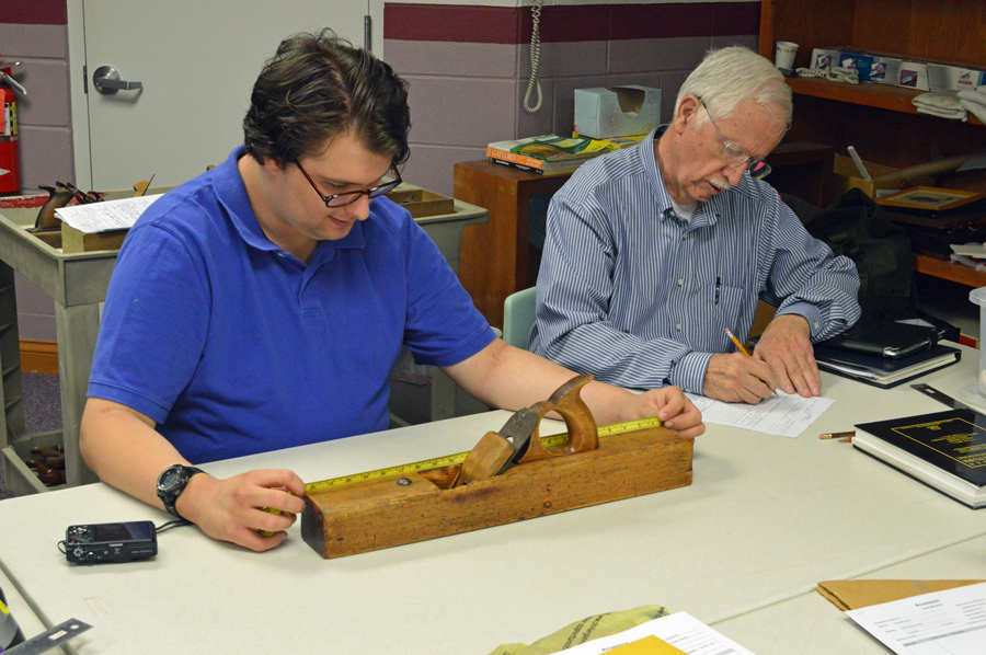 Sam assists Don in accessioning a jack plane at Garst Museum.