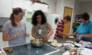 Students practice safe cooking procedures while making breakfast burritos.